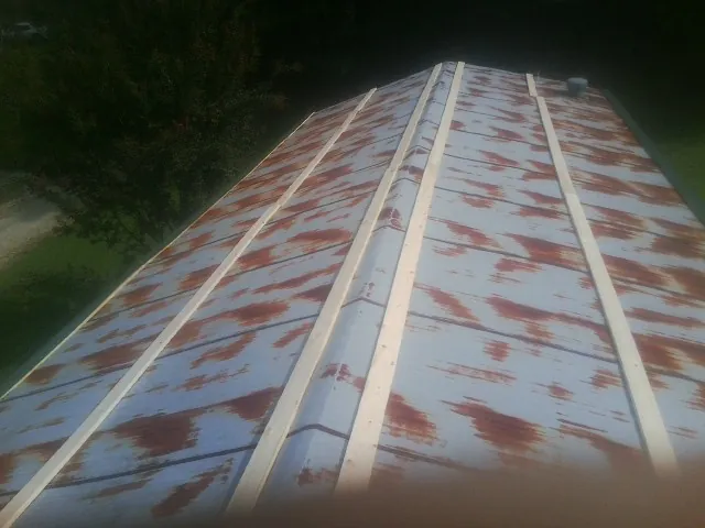 Rusted metal roof panels with new wood purlins before replacement — Storm Damage Roof Repair in Hassell by Roofing Brothers